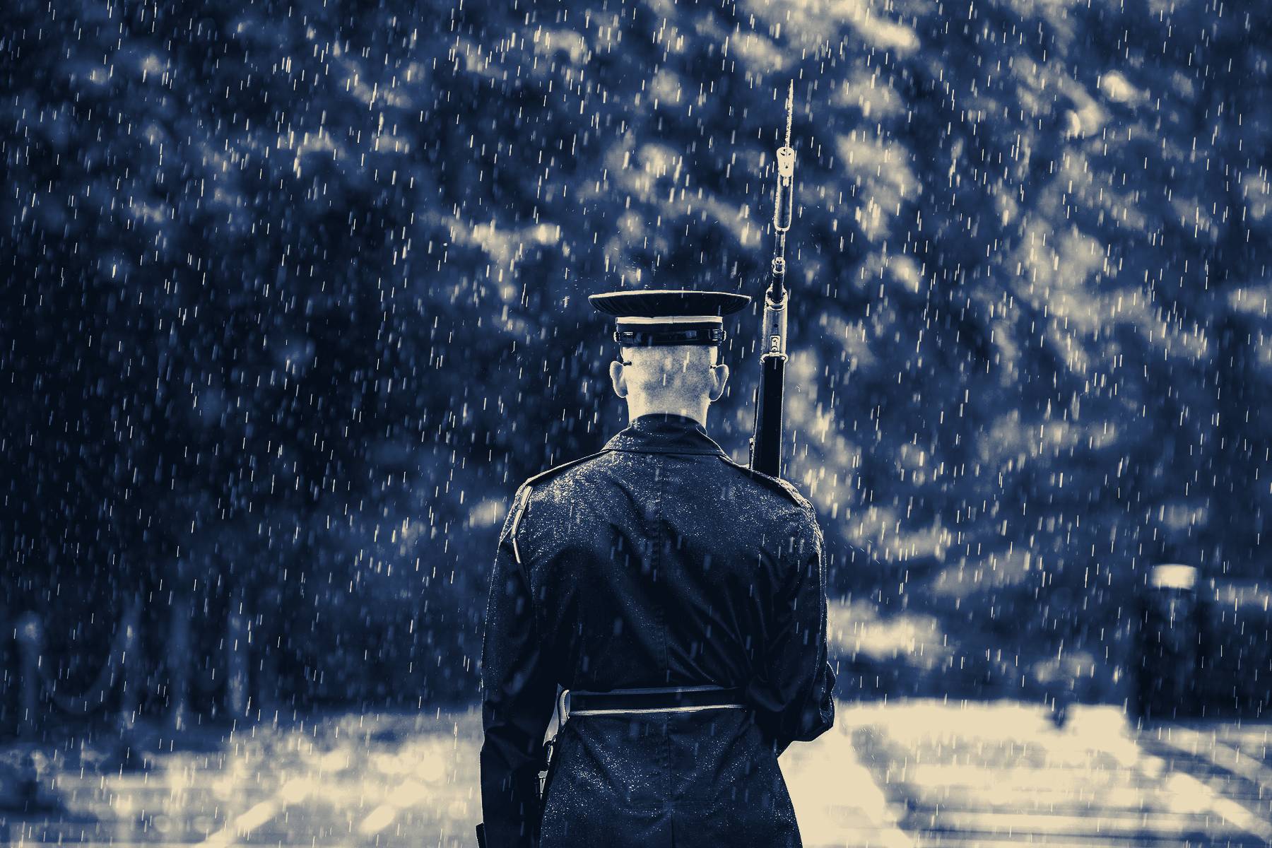 A sentinel of the Old Guard walking his post in the rain