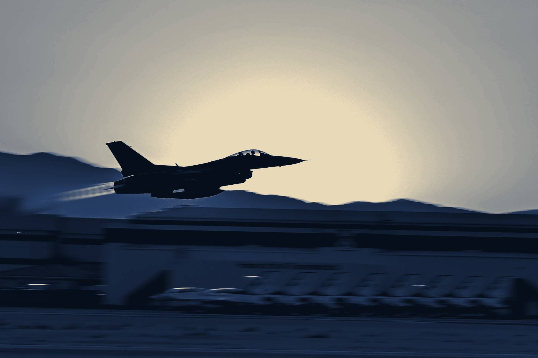 An F-16 lifting off into a low sun